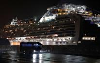 Buses believed to carry the U.S. passengers of the cruise ship Diamond Princess, where dozens of passengers were tested positive for coronavirus, leave at Daikoku Pier Cruise Terminal in Yokohama, south of Tokyo