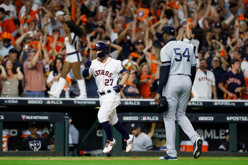 Astros' Jose Altuve hits a two-run home run off Yankees pitcher Aroldis Chapman to win Game 6 of the ALCS.