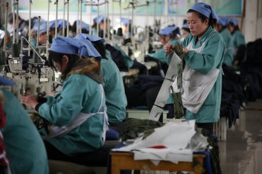 Workers are shown at a textile factory in Huaibei, Anhui province in China. China's exports and imports slowed for the second consecutive month, official data showed Friday, highlighting worsening conditions in the world's second-biggest economy amid global and domestic woes