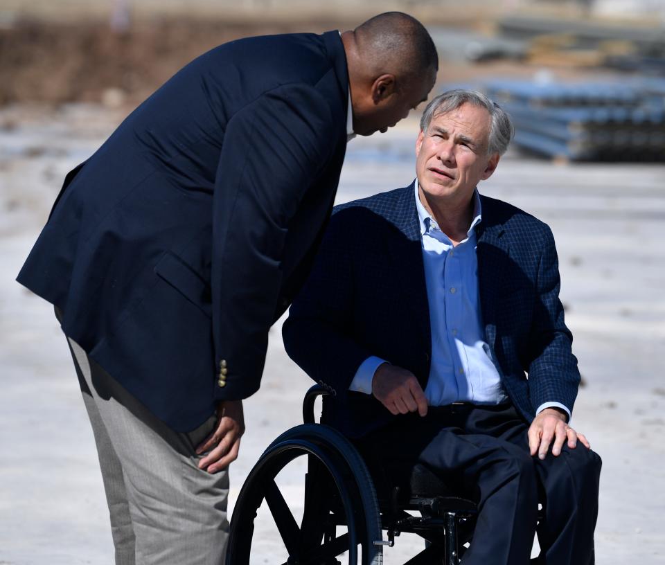 Abilene Mayor Anthony Williams speaks with Texas Governor Greg Abbott after an event at the under-construction Great Lakes Cheese factory on the edge of town Monday Feb. 7, 2022. 