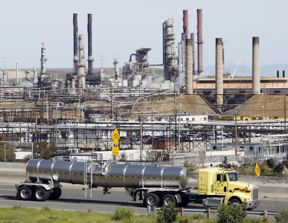 FILE - This March 9, 2010 file photo shows a tanker truck passing the Chevron oil refinery in Richmond, Calif. Chevron Corp. is facing millions of dollars in additional taxes for its refinery in Richmond after an appeals board ruled that the refinery was worth more than the county's assessment. (AP Photo/Paul Sakuma, File)