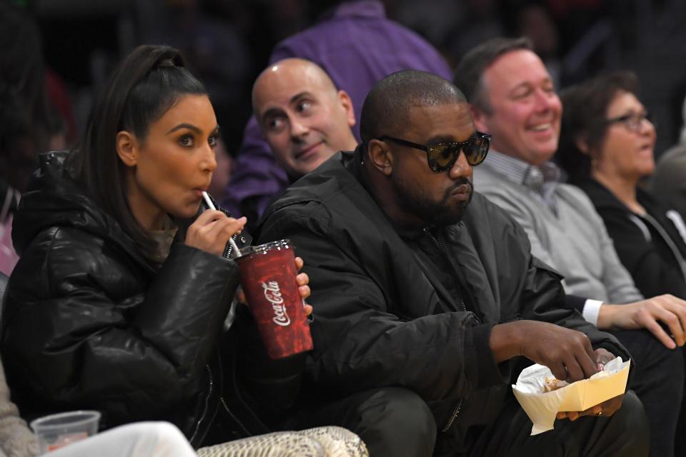 Kim Kardashian, left, and rapper Kanye West watch during the first half of an NBA basketball game between the Los Angeles Lakers and the Cleveland Cavaliers Monday, Jan. 13, 2020, in Los Angeles. The Lakers won 128-99. (AP Photo/Mark J. Terrill)