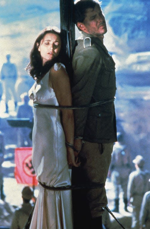Marion (Karen Allen) and Indiana Jones (Harrison Ford) hide their eyes to survive in "Raiders of the Lost Ark."