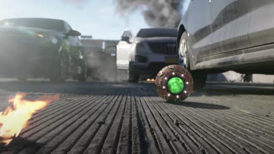 A glowing green round ball near cars on a road