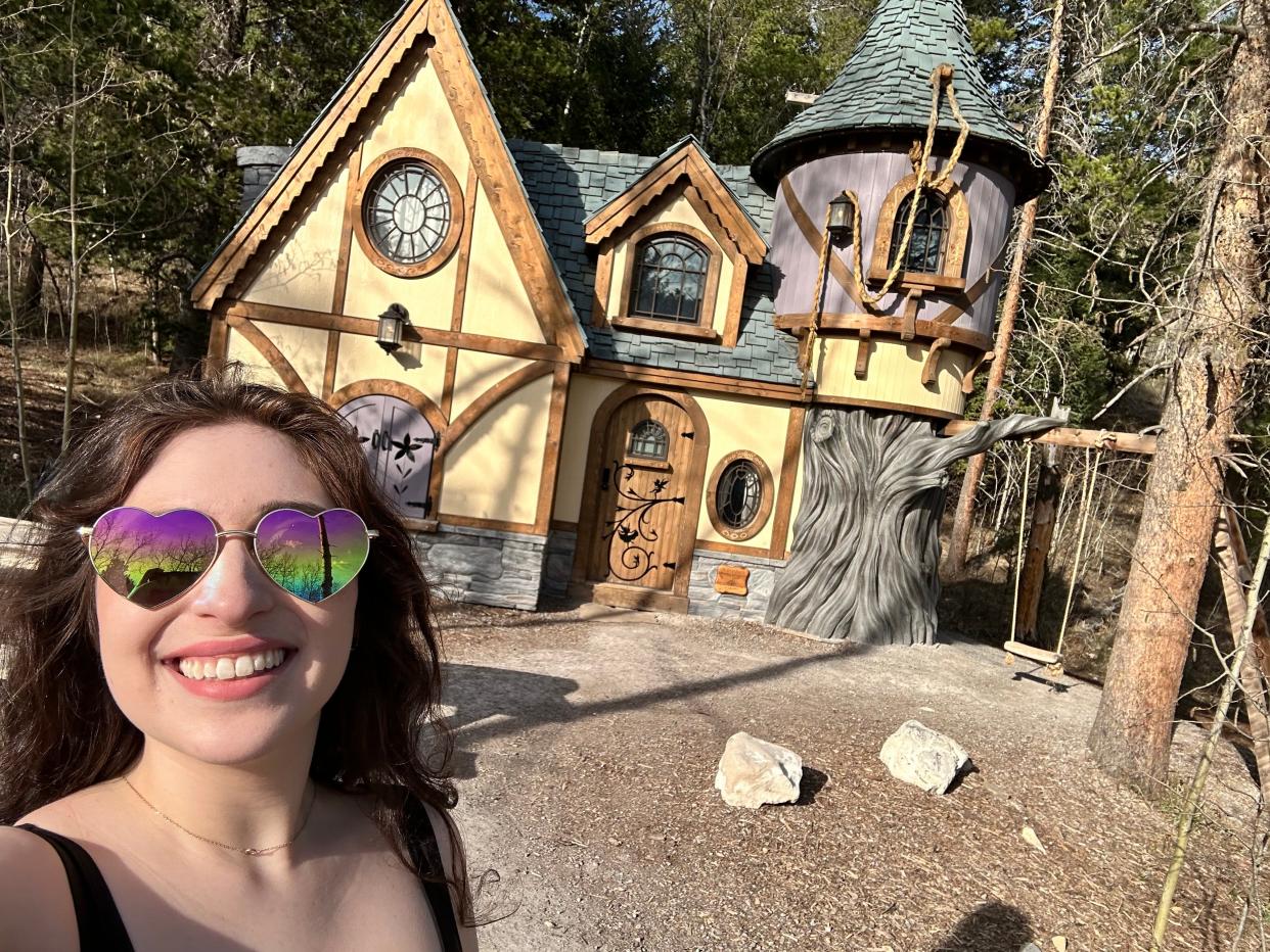 Paige DiFiore smiling in front of Rapunzel's Cottage