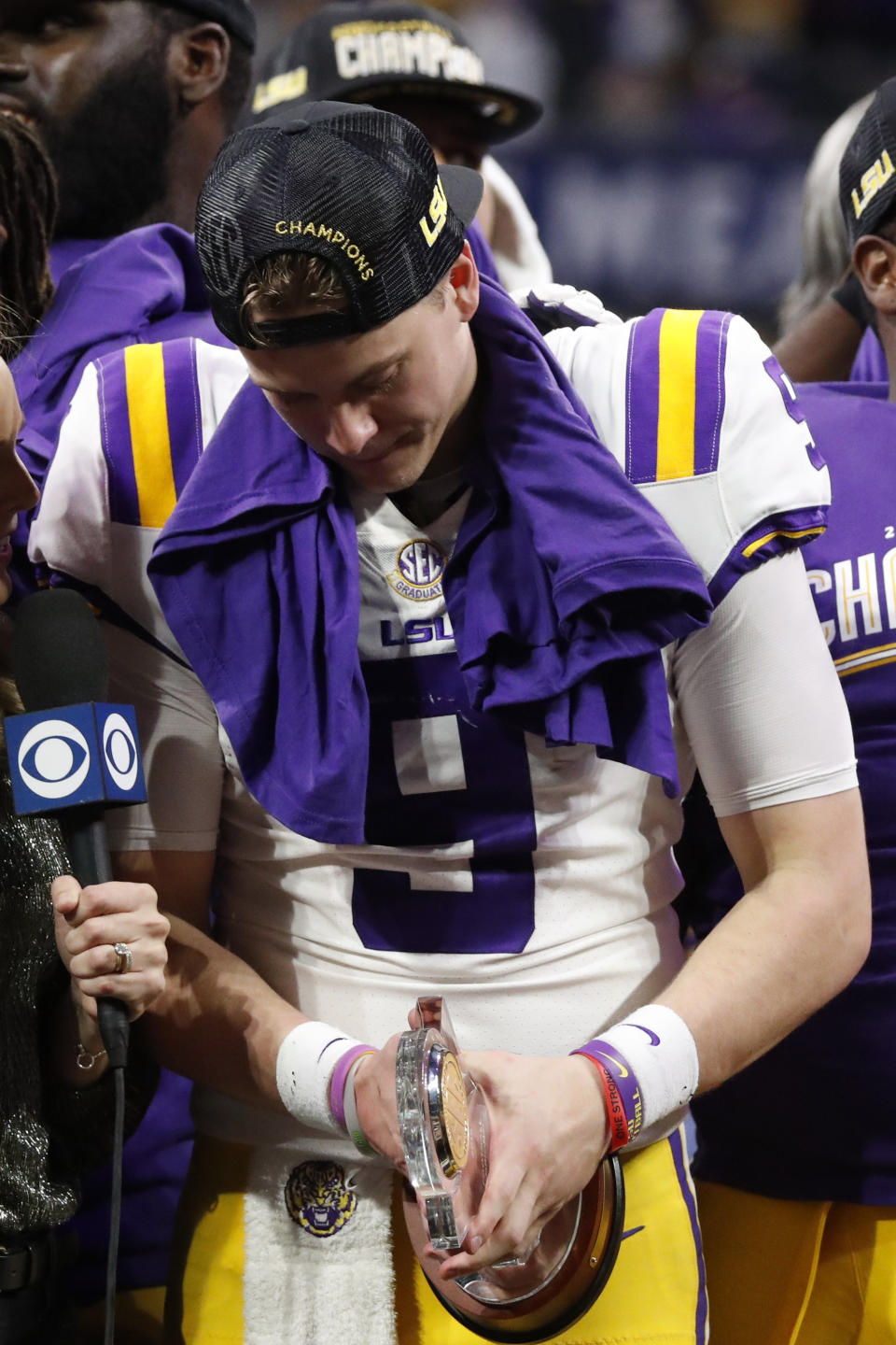 LSU quarterback Joe Burrow (9) holds his MVP trophy after the Southeastern Conference championship NCAA college football game against Georgia, Saturday, Dec. 7, 2019, in Atlanta. LSU won 37-10. (AP Photo/John Bazemore)