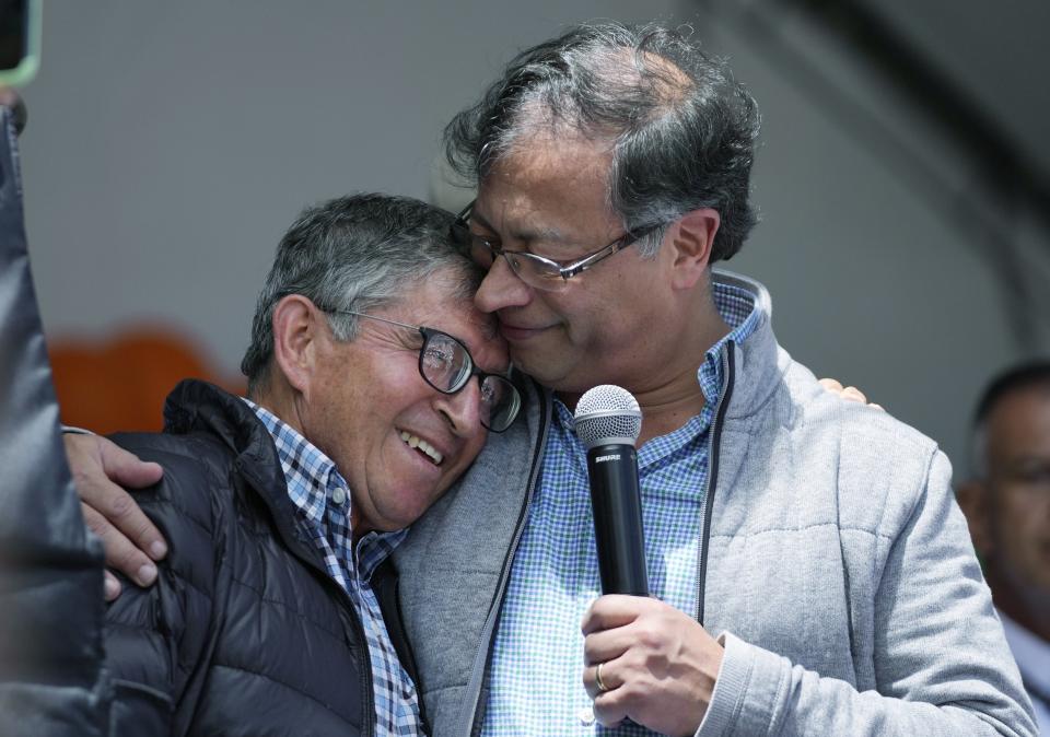 Gustavo Petro, presidential candidate with the Historical Pact coalition, embraces his former school teacher Salvador Medina, during a closing campaign rally in Zipaquira, Colombia, Sunday, May 22, 2022. Elections are set for May 29. (AP Photo/Fernando Vergara)