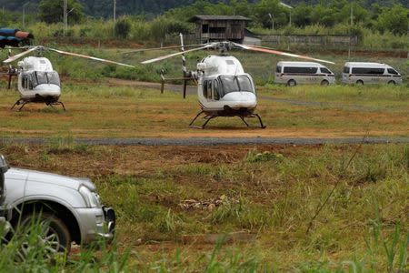 A general view shows helicopters expected to transport the schoolboys and their soccer coach who are trapped inside a flooded cave, in the northern province of Chiang Rai, Thailand, July 8, 2018. REUTERS/Tyrone Siu