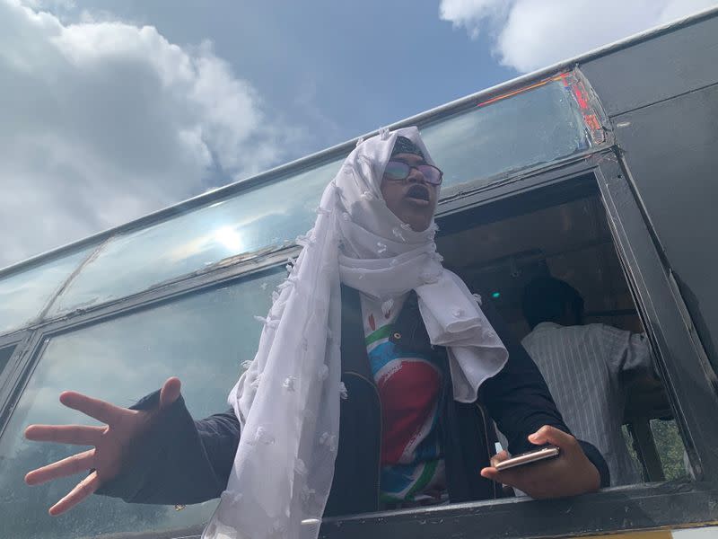 A demonstrator shouts slogans after she was detained during a protest against a new citizenship law, in Bengaluru