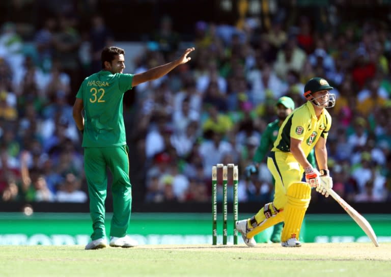 Australia's Dave Warner (R) nicks Pakistan's Hassan Ali to be caught behind during the fourth one-day international in Sydney on January 22, 2017