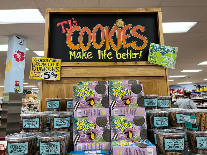 A display of cookies at Trader Joe's. A sign says "TJ's Cookies Make Life Better!".