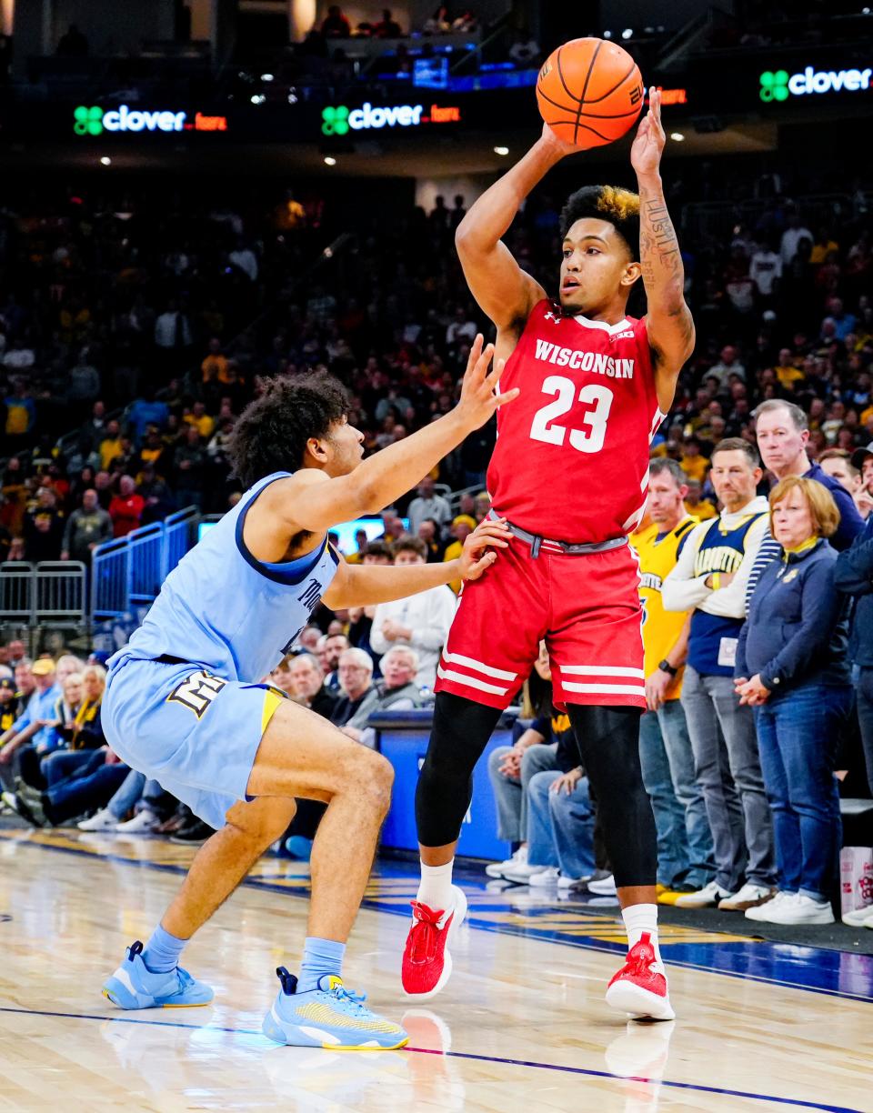 Wisconsin guard Chucky Hepburn fires up a three-pointer in overtime Saturday against Marquette at Fiserv Forum.
