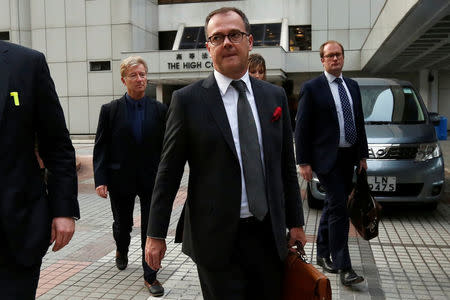 Michael Vidler (C), lawyer of British former banker Rurik Jutting, leaves the High Court with Professor Derek Perkins (L) and UK based psychologist Richard Latham (R) after a hearing in Hong Kong, China November 2, 2016. REUTERS/Bobby Yip