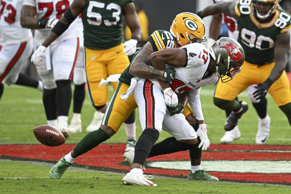 Green Bay Packers' Rasul Douglas hits Tampa Bay Buccaneers' Russell Gage and forces a fumble during the second half of an NFL football game Sunday, Sept. 25, 2022, in Tampa, Fla. (AP Photo/Jason Behnken)