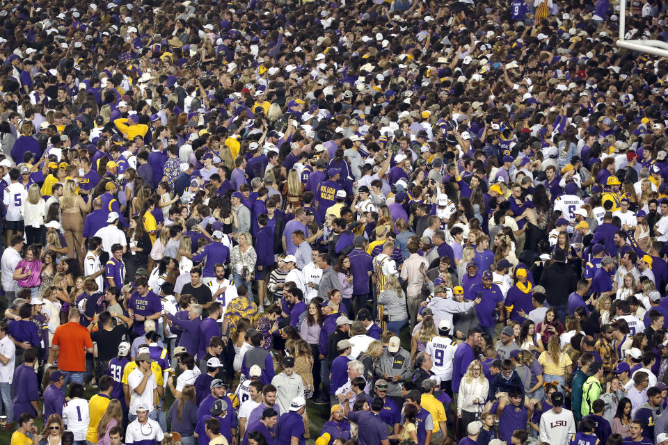 Fans gather on the field after an NCAA college football game between LSU and Alabama in Baton Rouge, La., Saturday, Nov. 5, 2022. LSU won 32-31 in overtime. (AP Photo/Tyler Kaufman)