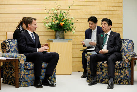Jeremy Hunt, British Secretary of State for Foreign and Commonwealth Affairs, talks with Japanese Prime Minister Shinzo Abe (R) during a courtesy call at the latter's official residence in Tokyo, Japan, April 15, 2019. Kimimasa Mayama/Pool via REUTERS