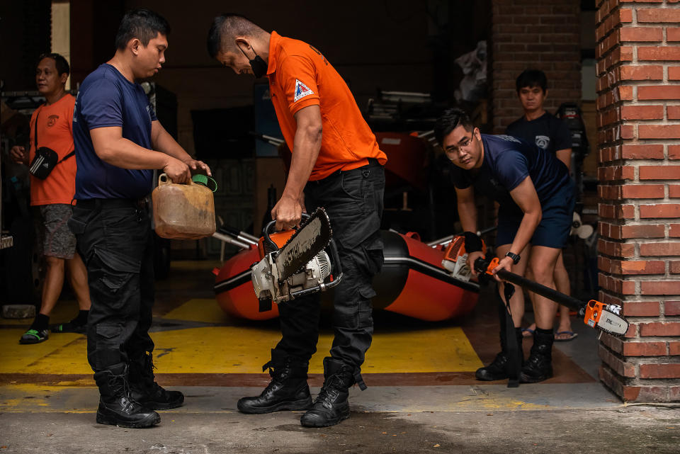 Members of the Disaster Risk Reduction and Management Office prepare rubber boats and life vests ahead of Super Typhoon Noru making landfall, at their headquarters in Quezon City, suburban Manila on September 25, 2022. (Photo by KEVIN TRISTAN ESPIRITU / AFP) (Photo by KEVIN TRISTAN ESPIRITU/AFP via Getty Images)