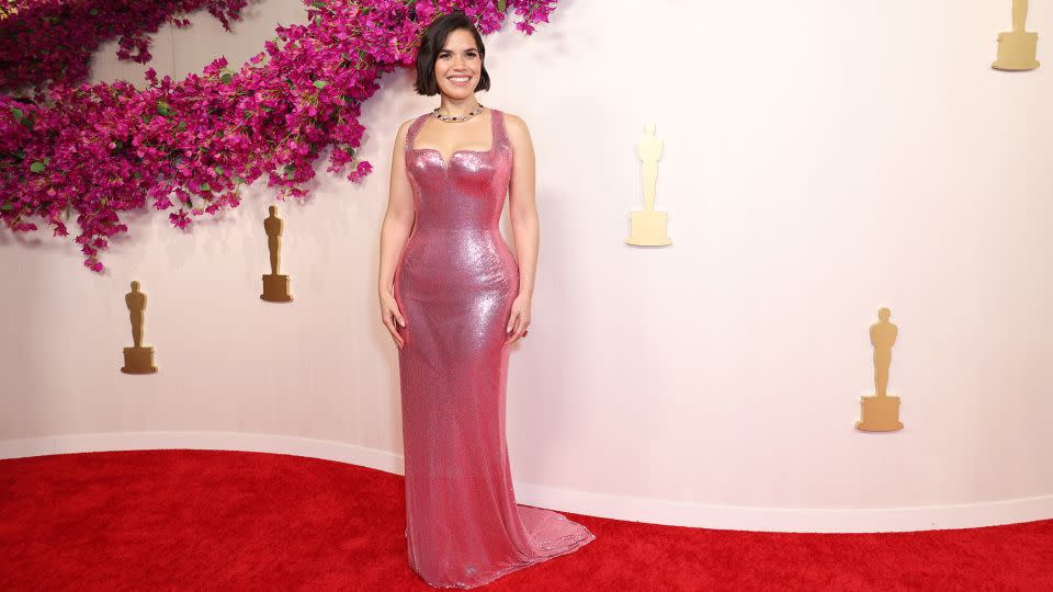 "Barbie" actor America Ferrera arrives at the 96th Academy Awards wearing a pink custom Atelier Versace pink gown and bold Pomellato jewelry. - JC Olivera/Getty Images