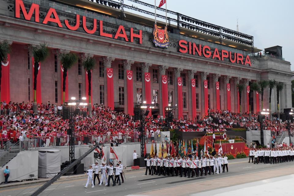 Spectators watch a procession during the 54th National Day Parade in Singapore on August 9, 2019. (Photo by Roslan RAHMAN / AFP)        (Photo credit should read ROSLAN RAHMAN/AFP/Getty Images)