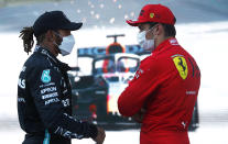 Ferrari driver Charles Leclerc of Monaco, right, speaks with Mercedes driver Lewis Hamilton of Britain after taking pole position during the qualifying session at the Baku Formula One city circuit in Baku, Azerbaijan, Saturday, June 5, 2021. The Azerbaijan Formula One Grand Prix will take place on Sunday. (Maxim Shemetov, Pool via AP)