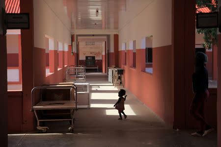 A toddler runs through Chiulo Hospital in Cunene province, Angola February 24, 2018. REUTERS/Stephen Eisenhammer