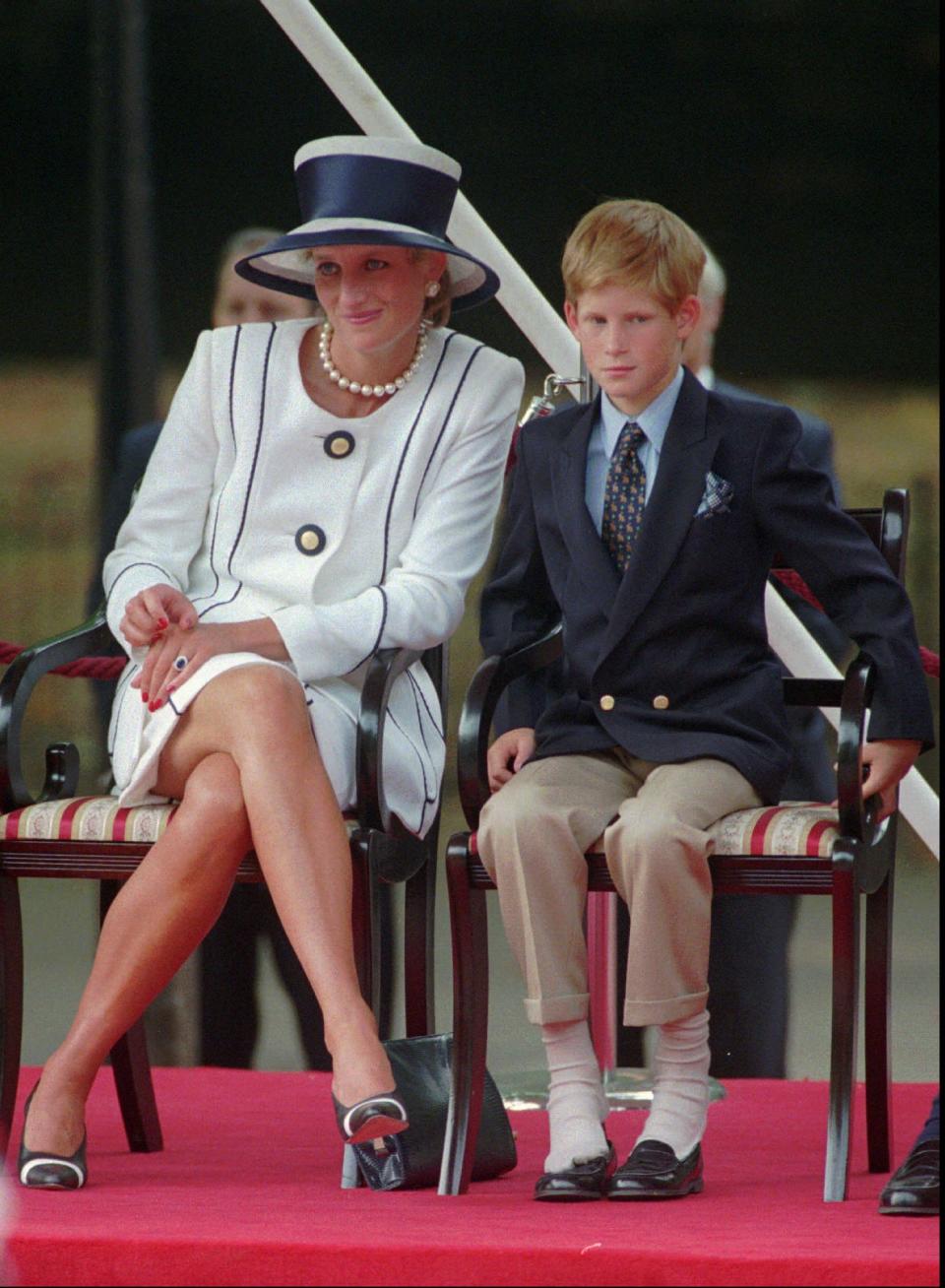 Britain's Princess of Wales sits next to her yougest son Prince Harry during V-J day celebrations in London Saturday August 19, 1995. (AP Photo/Alastair Grant)
