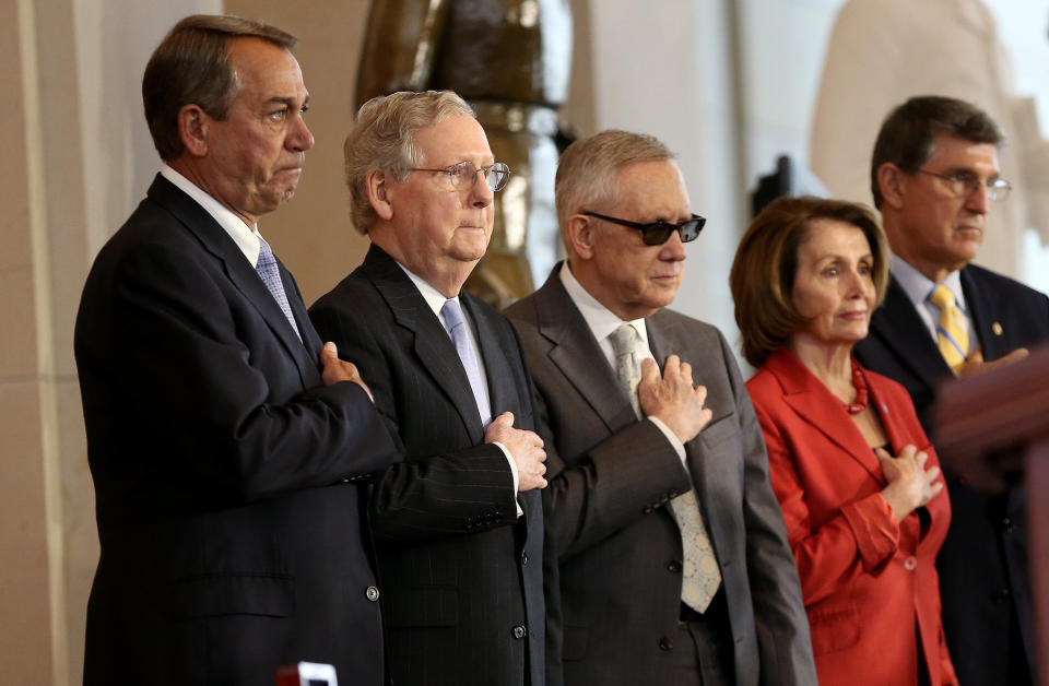 From left: U.S. Speaker of the House John Boehner (R-Ohio), Senate Majority Leader Mitch McConnell (R-Ky.), Senate Minority Leader Harry Reid (D-Nev.), House Minority Leader Nancy Pelosi (D-Calif.) and Sen. Joe Manchin (D-W.Va.) place their hands over their hearts during the playing of the national anthem during a presentation ceremony for the Congressional Gold Medal in recognition of the American Fighter Aces' service to the United States at the U.S. Capitol on May 20, 2015. Congress honored the service of the pilots with the highest civilian honor Congress can bestow.