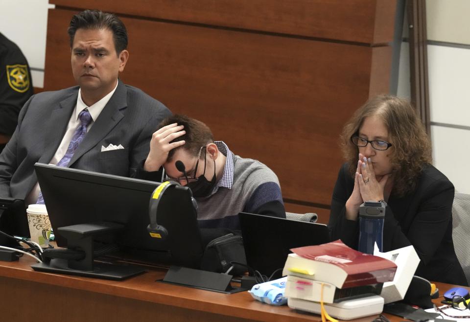 Marjory Stoneman Douglas High School shooter Nikolas Cruz looks down as Assistant State Attorney Mike Satz delivers an opening statement in the penalty phase of his trial at the Broward County Courthouse in Fort Lauderdale on Monday July 18, 2022. Cruz previously plead guilty to all 17 counts of premeditated murder and 17 counts of attempted murder in the 2018 shootings. (Carline Jean/South Florida Sun Sentinel via AP, Pool)