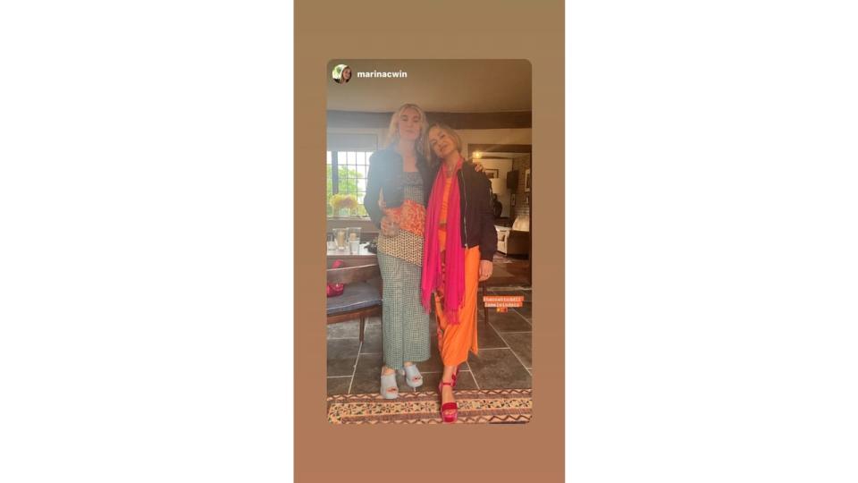 Amelia Windsor in an orange dress and pink scarf