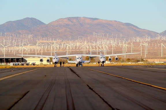 Virgin Galactic's SpaceShipTwo is seen attached to its WhiteKnightTwo carrier aircraft on a runway at the Mojave Air and Space Port in Mojave, California, during an Oct. 7, 2014, glide test flight. The spacecraft will resume rocket-powered test