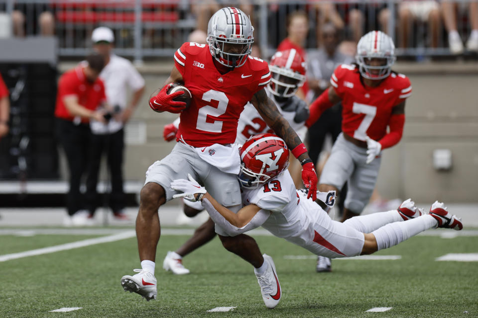 Youngstown State defensive back Makai Shahid, right, tackles Ohio State receiver Emeka Egbuka during the first half of an NCAA college football game Saturday, Sept. 9, 2023, in Columbus, Ohio. (AP Photo/Jay LaPrete)