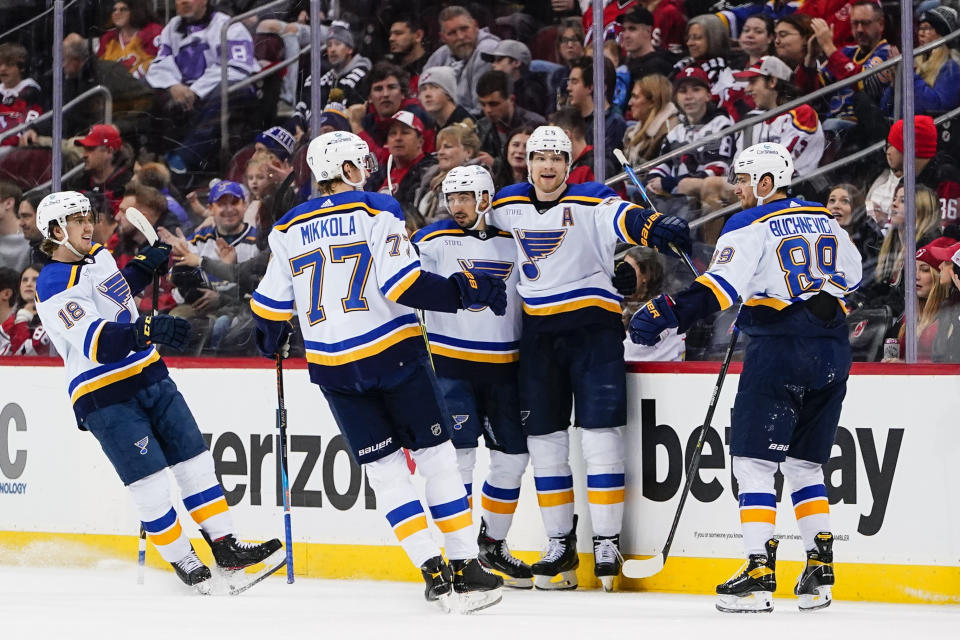 St. Louis Blues' Jordan Kyrou, center, celebrates with teammates Robert Thomas (18), Niko Mikkola (77), Colton Parayko (55) and Pavel Buchnevich (89) after scoring a goal against the New Jersey Devils during the first period of an NHL hockey game Thursday, Jan. 5, 2023, in Newark, N.J. (AP Photo/Frank Franklin II)