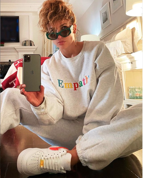 Jennifer Lopez in a grey tracksuit