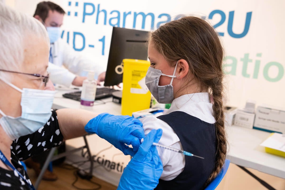 A school pupil having a Covid vaccine (PA) (PA Wire)