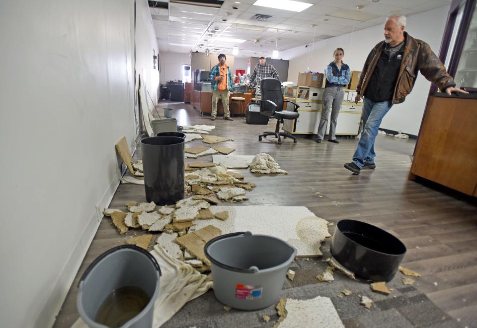 Mike Miller of Miller's Diamond Jewelry examines some of the water damage in his store, when it was in the Appleseed Center. The business recently relocated to the Ace Hardware plaza on Lexington Avenue.