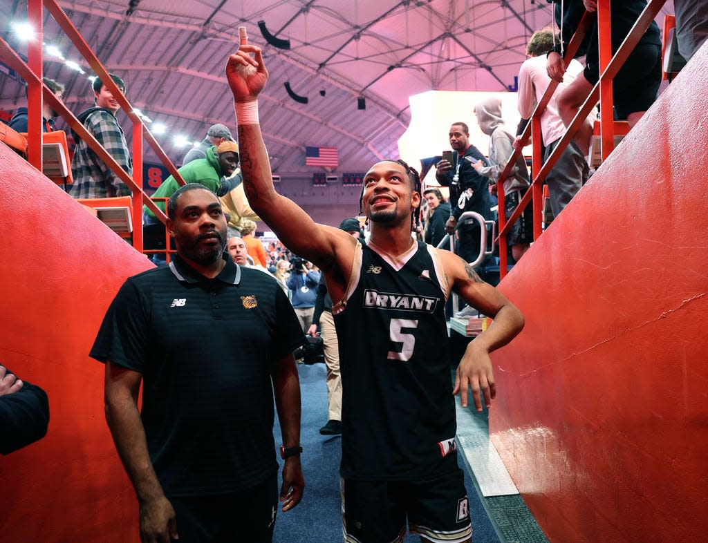 Bryant University guard Charles Pride (5) waves to friends and family after their game against Syracuse on Saturday at the JMA Wireless Dome.