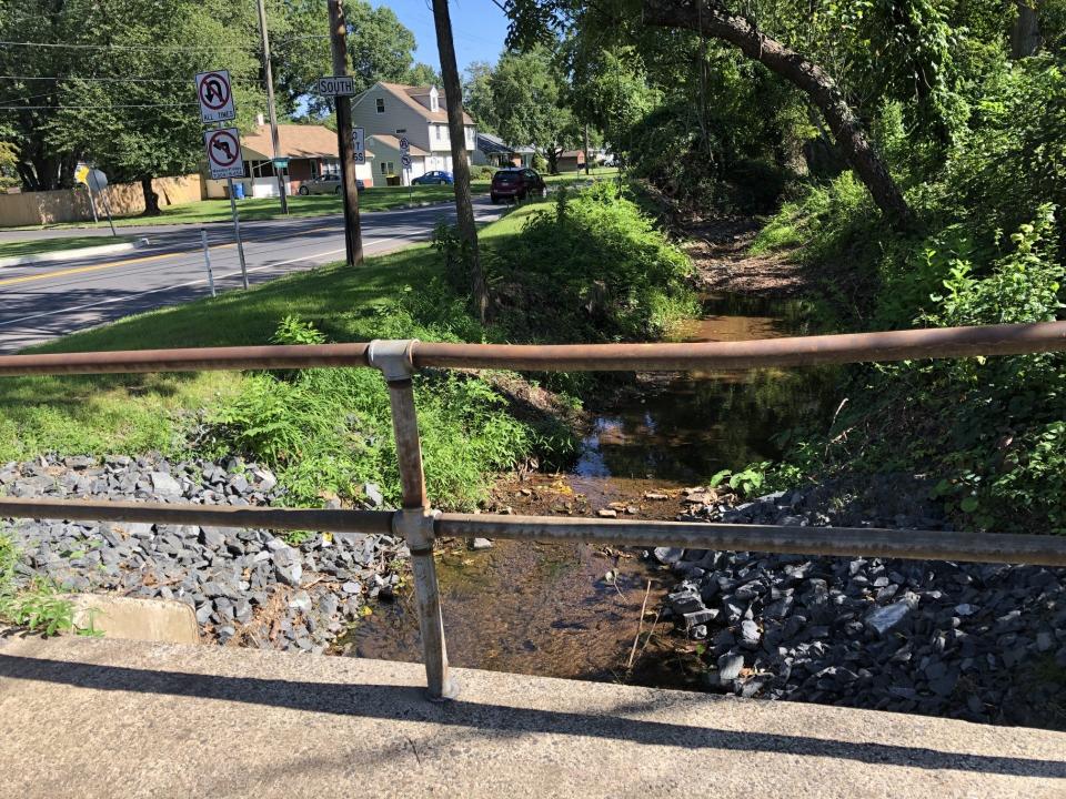 From the bridge on Highland Drive, the unnamed stream that runs along Taylorsville Road beside the Maplevale housing development looks picturesque.  The small stream turned into a raging river of water on July 15 when it flooded the Maplevale neighborhood.  Lower Makefield cleared out much debris from the stream since then to allow the water to flow more easily under the bridge and around the neighborhood.