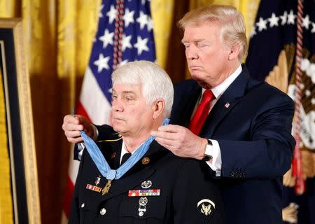 U.S. President Donald Trump awards the Medal of Honor to James McCloughan, who served in the U.S. Army during the Vietnam War, during a ceremony at the White House in Washington, U.S. July 31, 2017. REUTERS/Joshua Roberts