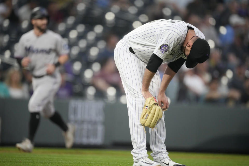 Colorado Rockies starting pitcher Austin Gomber reacts after giving up a two-run home run to Miami Marlins' Garrett Cooper in the sixth inning of a baseball game Tuesday, May 23, 2023, in Denver. (AP Photo/David Zalubowski)