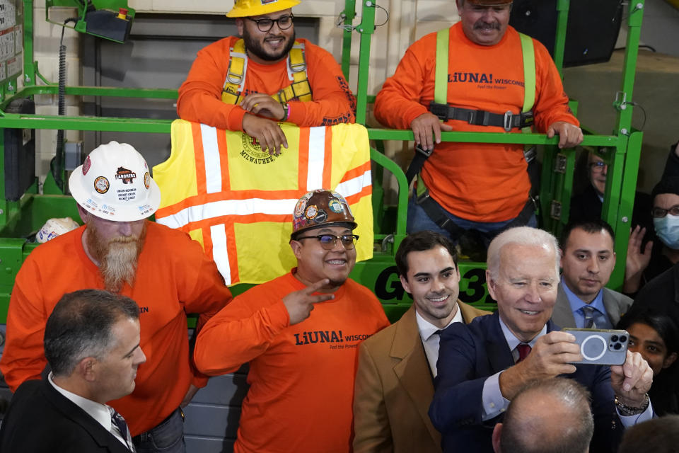 President Joe Biden takes a photo with workers after delivering remarks on his economic agenda at LIUNA Training Center, Wednesday, Feb. 8, 2023, in DeForest, Wis. (AP Photo/Patrick Semansky)