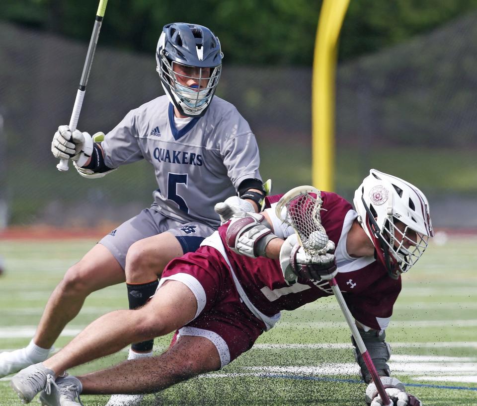 Anthony DiCenso, right, of La Salle Academy, tries to slip past Alexander Ritson-Parsons of Moses Brown during a game in May.