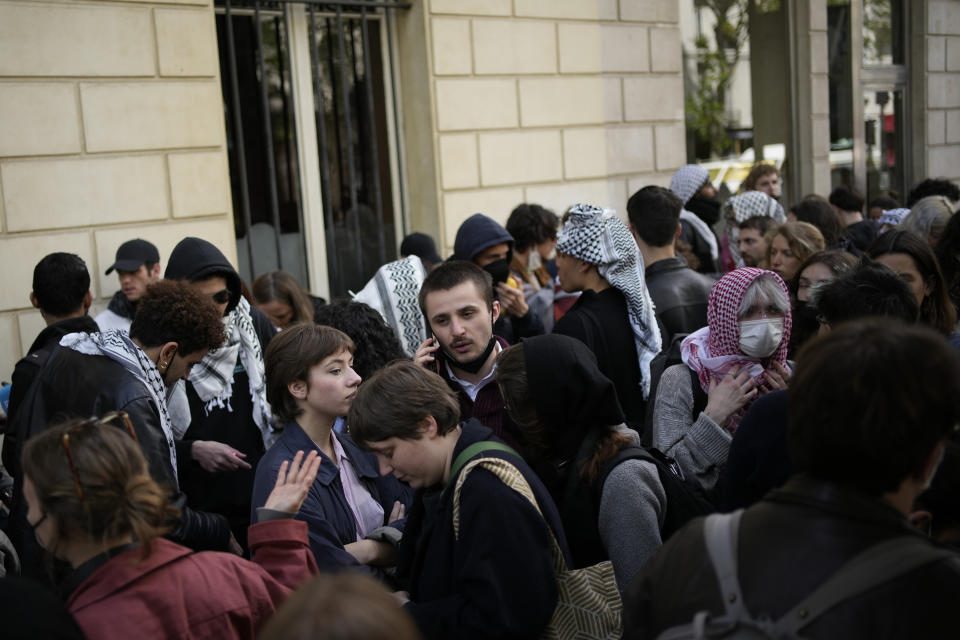 Students gather near Sciences Po university Friday, May 3, 2024 in Paris. French police peacefully evacuated dozens of students from a building of the Paris Institute of Political Studies, known as Sciences Po, who had gathered there in support of Palestinians, echoing similar encampments and solidarity demonstrations across the United States. (AP Photo/Christophe Ena)