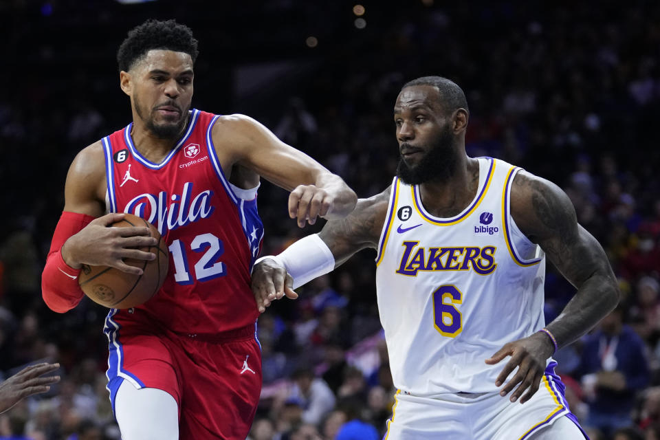 Philadelphia 76ers' Tobias Harris, left, tries to get past Los Angeles Lakers' LeBron James during the first half of an NBA basketball game, Friday, Dec. 9, 2022, in Philadelphia. (AP Photo/Matt Slocum)