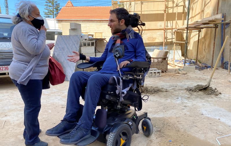 Marc Torbey el Helou, head of Lebanese NGO Offre Joie, gestures as he talks with Salwa Awdeh in Beirut