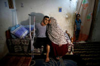 Palestinian cyclist Alaa Al-Daly, 21, who lost his leg by a bullet fired by Israeli troops, is welcomed by his mother at his house in Rafah, southern Gaza Strip, April 18, 2018. REUTERS/Suhaib Salem