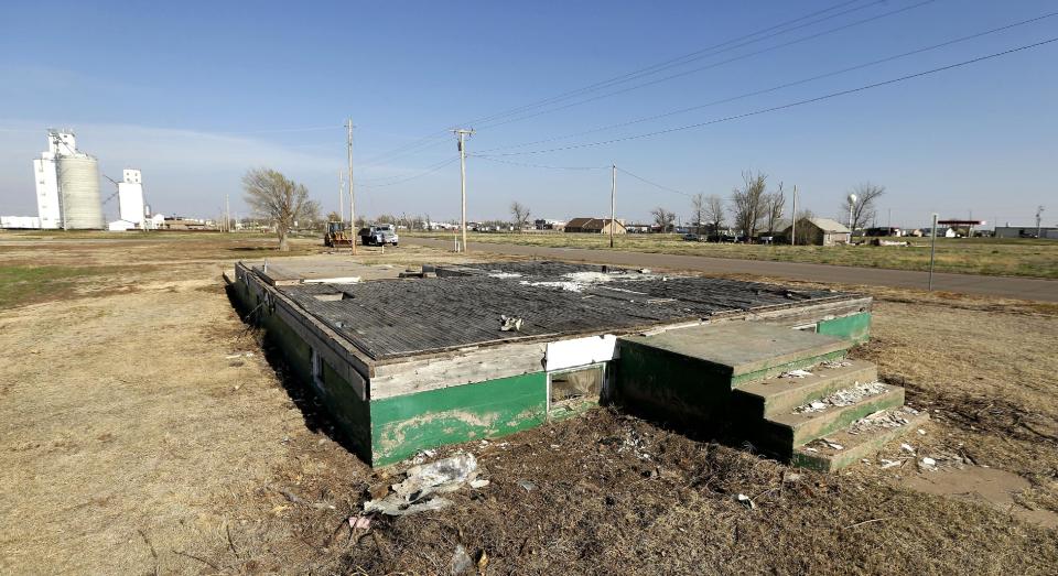 In this photo taken April, 18, 2014, a home's foundation stands in a empty neighborhood where houses once were in Greensburg, Kan. Seven years after an EF-5 tornado destroyed most of the community of 1,500, Greensburg's population stands at about 850. (AP Photo/Charlie Riedel)
