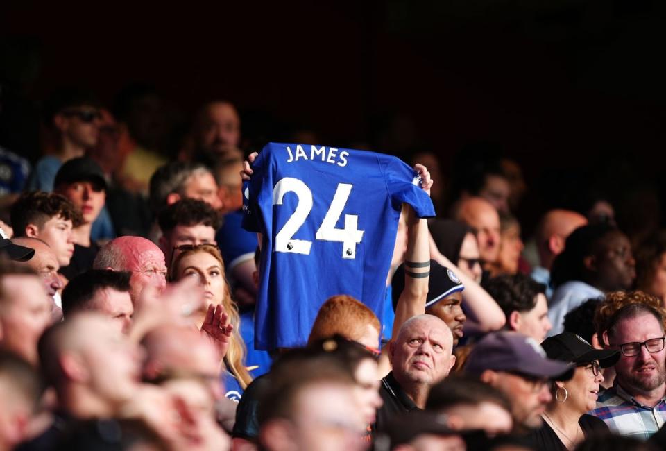 A Chelsea fan holds aloft a James shirt after the game (Mike Egerton/PA Wire)