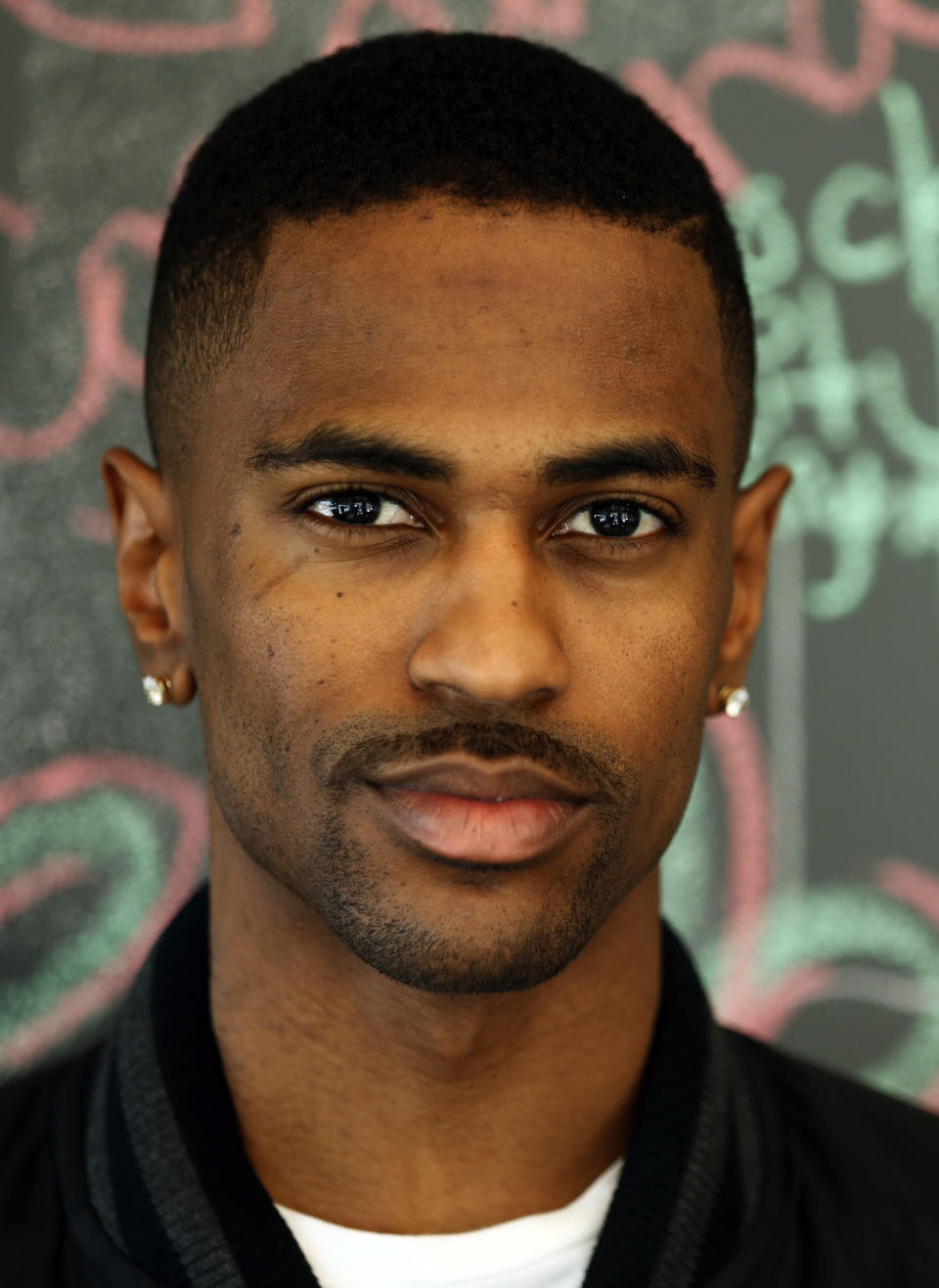 In this Friday, Aug. 16, 2013 photo, Big Sean poses for a portrait at Island Def Jam in Santa Monica, Calif. The rapper put Miley Cyrus front-and-center in his recent “Fire” music video, with his face seen just briefly in the background. Then he released “Control,” featuring an explosively competitive verse from Kendrick Lamar that overshadowed his own and has become the talk of hip-hop. (Photo by Matt Sayles/Invision/AP)