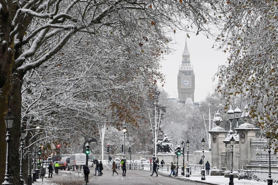 People walk on the street in front of The Elizabeth Tower, more commonly known as Big Ben, as cold weather continues, in London (REUTERS)