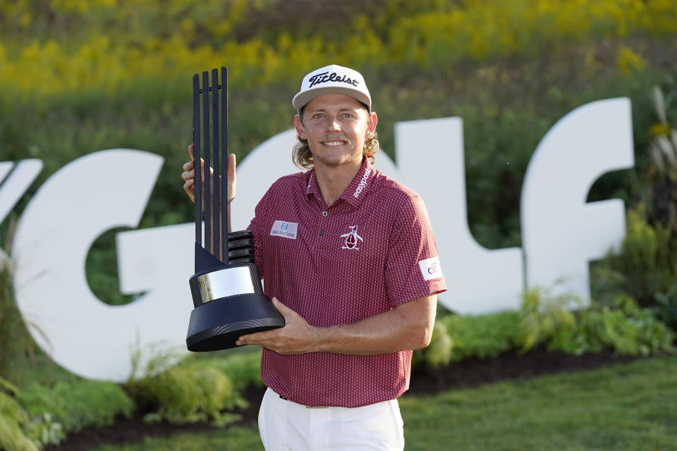 Cameron Smith poses with the champion's trophy after winning the LIV Golf Invitational-Chicago tournament Sunday, Sept. 18, 2022, in Sugar Hill, Ill. (AP Photo/Charles Rex Arbogast)